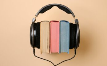 black corded headphones with colorful books in between